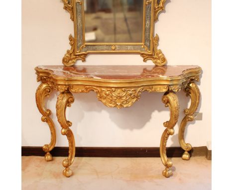 Gilded wood console Italy, 20th centuryshaped line structure carved with vegetal and floral motifs, moved line legs decorated