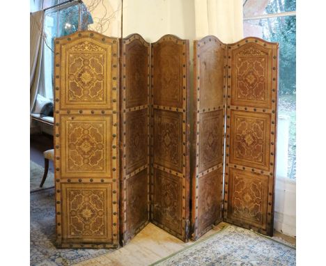 Five-fold leather screen Italy, 19th-20th centurygilded decorations with plant and scroll motifs, defects190x265 cm. (aperto)