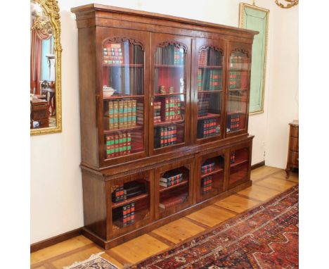 Rosewood bookcase XIX sec.front with eight glass doors decorated with openwork elements and motifs of volutes271x265x42 cm.