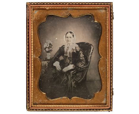 * Daguerreotypes. Two hand-tinted daguerreotypes of unidentified women, circa 1855, the first a middle-aged woman in a bonnet