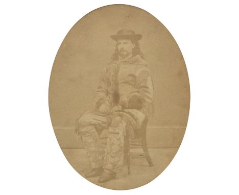 * Cody (William Frederick 'Buffalo Bill', 1846-1917). A full-length portrait of Cody in buckskins seated on a chair, circa la