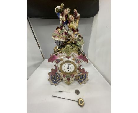 A DECORATIVE FRENCH PORCELAIN MANTLE CLOCK WITH A COURTING COUPLE AND GRAPES DECORATION 