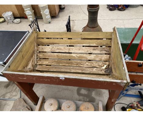 A WOODEN MANGER TROUGH PLANTER 