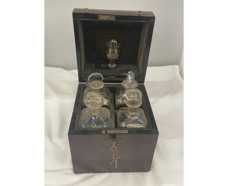 A VINTAGE MAHOGANY LIQUER CASE WITH FOUR DECANTERS AND ONE GLASS COMPLETE WITH LABELLED KEY 