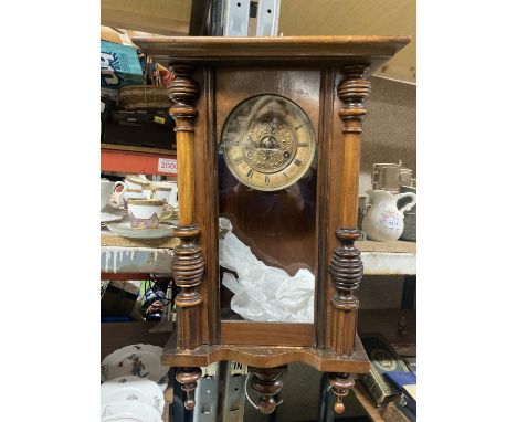 A MAHOGANY CASED WALL CLOCK WITH COLUMN DECORATION TO INCLUDE THE PENDULUM AND KEY 