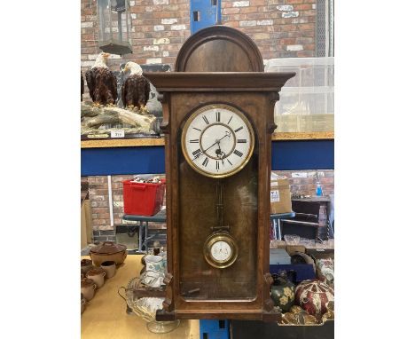 A VINTAGE WALL CLOCK WITH AN ENAMELLED FACE IN A BURR WALNUT CASE - BEARS THE INITIALS R = A ON THE PENDULUM 
