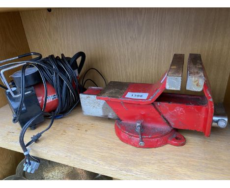 A SMALL COMPRESSOR AND A BENCH VICE 