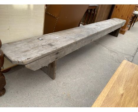 A VICTORIAN PINE BENCH, 10'4" LONG, WITH CANTED CORNERS 