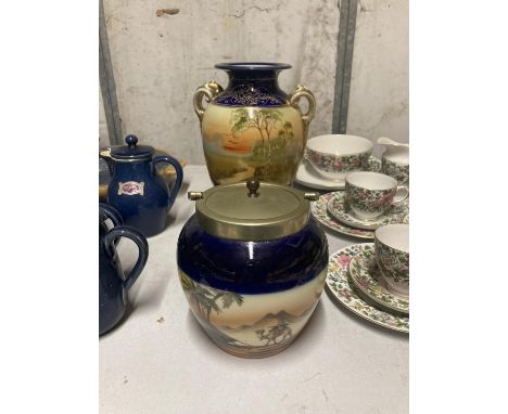 TWO PIECES OF NORITAKE TO INCLUDE A BLUE AND GILT HANDLED VASE WITH A PASTORAL PRINT PLUS A METAL LIDDED BISCUIT BARREL WITH 