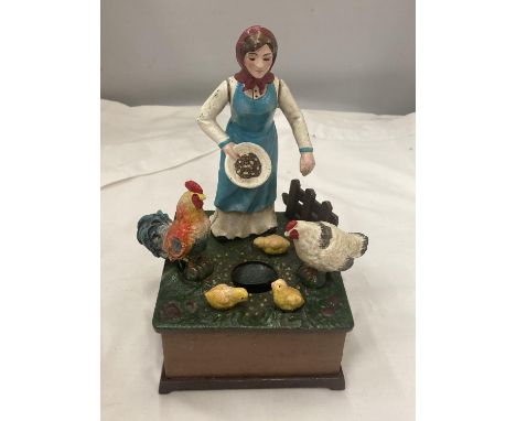 A VINTAGE STYLE CAST MONEY BANK OF A LADY FEEDING CHICKENS, TURN THE HANDLE AND 'OLD McDONALD HAD A FARM' PLAYS 