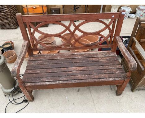 A WOODEN SLATTED GARDEN BENCH 