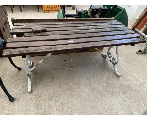 A WOODEN SLATTED GARDEN BENCH/TABLE WITH CAST BASE 