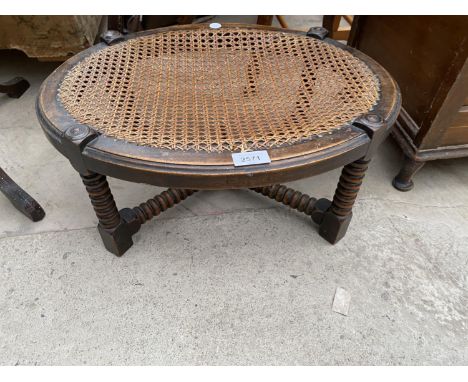 AN EARLY 20TH CENTURY OVAL OAK STOOL WITH SPLIT CANE TOP ON BOBBIN TURNED LEGS, 20X15" 