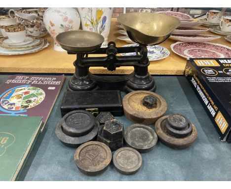 A VINTAGE SET OF CAST SCALES WITH BRASS PANS PLUS A QUANTITY OF WEIGHTS 