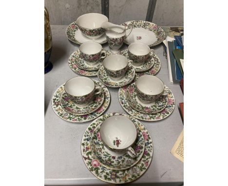 A CROWN STAFFORDSHIRE TEASET IN A FLORAL PATTERN TO INCLUDE SERVING BOWLS, CREAM JUG, SUGAR BOWLS, CUPS, SAUCERS AND SIDE PLA