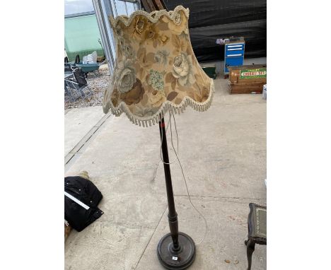 A STANDARD LAMP COMPLETE WITH SHADE 