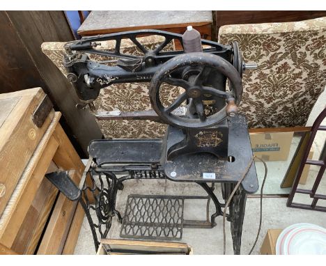 A VINTAGE INDUSTRIAL SINGER SEWING MACHINE WITH TREADLE BASE 