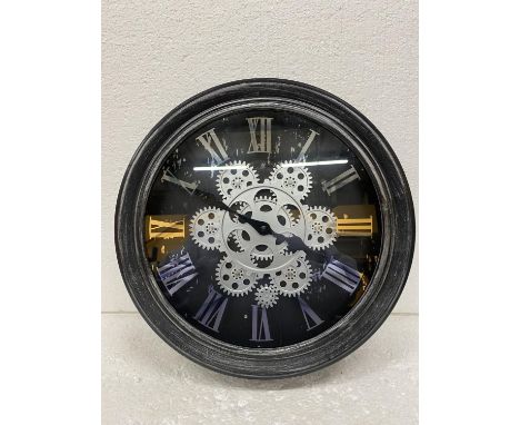 A WALL CLOCK WITH MOVING COGS ON THE FACE DIAMETER  33CM 