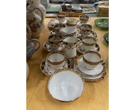 A ROYAL ALBERT TEA SET TO INCLUDE CUPS AND SAUCERS, CAKE PLATES, SIDE PLATES, SUGAR BOWL, CREAM JUGS, ETC 