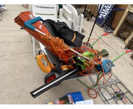 AN ASSORTMENT OF GARDEN TOOLS TO INCLUDE AN ELECTRIC HEDGE TRIMMER, A FLYMO GARDEN VAC AND A WHEEL BARROW ETC 