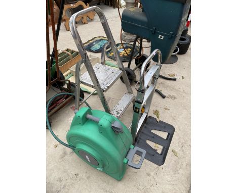 A FOLDING SACK TRUCK, A STEP LADDER AND A HOSE REEL 