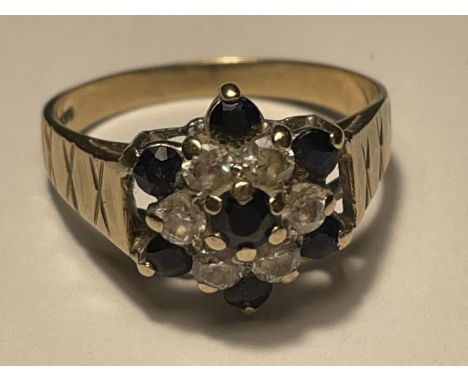 A 9 CARAT GOLD RING WITH SAPPHIRES AND CUBIC ZIRCONIAS IN A FLOWER DESIGN SIZE R 