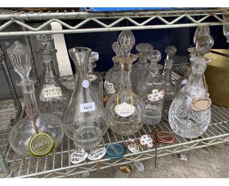 A LARGE QUANTITY OF GLASS DECANTORS WITH VARIOUS CERAMIC DECANTOR LABELS 