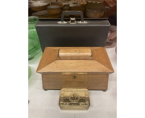 AN OAK SARCOPHOGUS SHAPED TEA CADDY IN NEED OF RESTORATION, A REPLICA WW1 CHRISTMAS TIN PLUS A BRIEFCASE 
