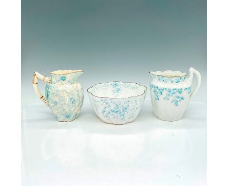 Two pitchers and one bowl with fluted textures, fine light blue floral designs, and scalloped edges with gold gilding. Wilema