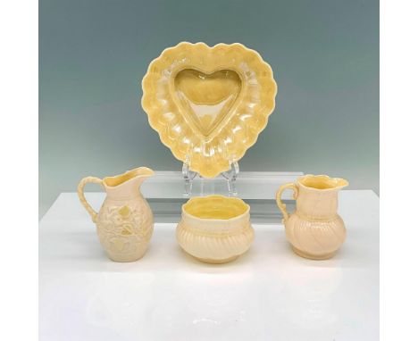 A set of 4 glazed items consisting of 1 sugar bowl, 2 creamers, and 1 heart shaped bowl all with various relief patterns. Bel