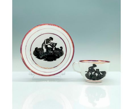 A white teacup and saucer set with iridescent pink borders that have a painting of a 19th century woman helping her child tak
