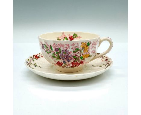 White cup and saucers that are adorned with colorful flowers. The cup is in the Fairy Dell patter, and the saucer is in the W