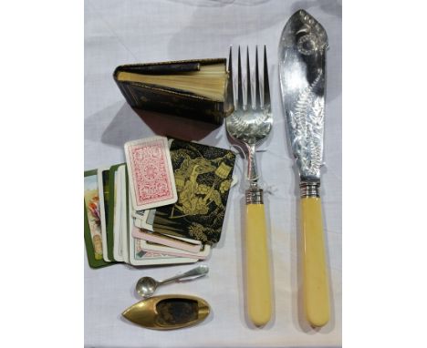 A pair of Victorian bone handled fish servers with a leather bound miniature notebook and playing cards 