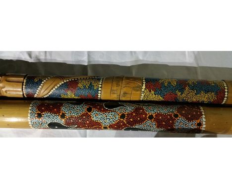 A didgeridoo carved with snake entwined with tribal decoration together with a rain stick with tribal decoration (2) 