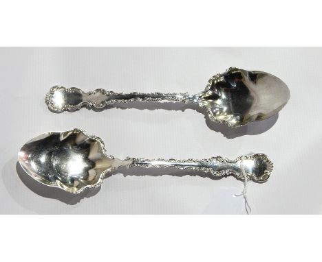 A pair of Victorian silver salad servers with scrollwork borders, Sheffield 1898, 6oz approx. 