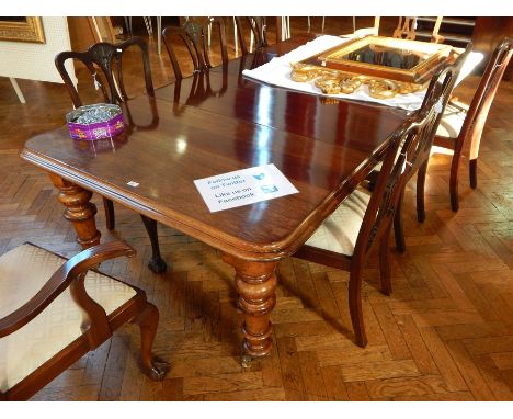 Victorian mahogany wind-out dining table with serpentine thumb moulded edging, on ring turned tapering supports, brass caps a