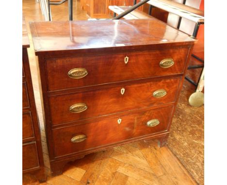 A mahogany small chest of drawers with three graduated drawers, ivory shield escutcheons, on bracket feet 