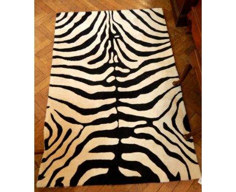 A zebra print carpet, 180cm x 120cm 

* PLEASE NOTE THIS LOT WILL CARRY VAT ON THE HAMMER PRICE 