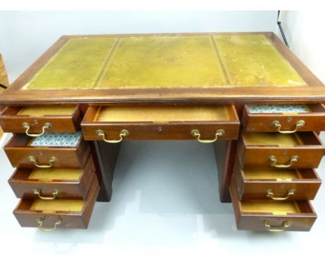Early 20th century mahogany pedestal desk with leather inset top over central drawer and eight graduated opposing drawers on 