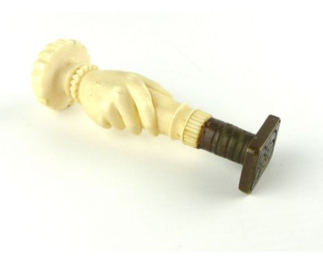 Oriental ivory and brass seal, pumpkin rib finial over a hand holding the seal, c 1930.   