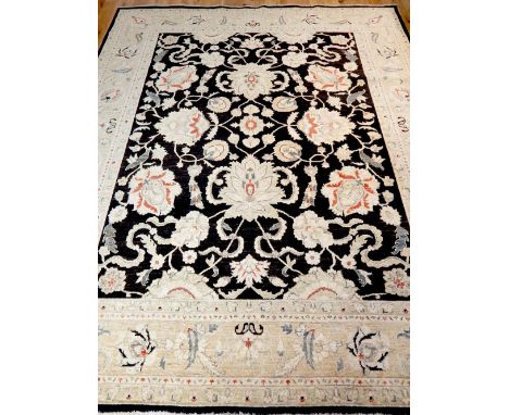 Large Ziegler style carpet, the centre floral design over indigo ground, within cream borders, 295 x 243cm. 