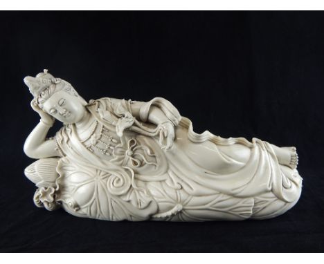 Chinese statue, study of Guan Yin goddess, lying on a lotus flower pod, blanc de Chine, impress stamps to rear, 21 x 41cm w. 
