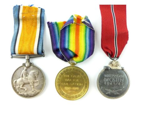 First World War medal pair awarded to SJT R H Curle R Fus and a German 1941 / 42 Winterschlacht medal. 