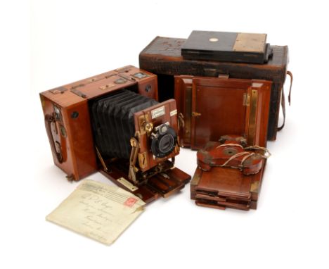 A Sanderson Tropical ModelÂ Roll Film 4Ã—5 Plate &amp; Rollfilm Camera, 1912, polished teak body with lacquered-brass fitting