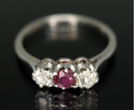 A diamond and ruby cluster ring, the stones weighing approx. 0.20 carats each, band marked 'PLAT', gross wt. 2.8g, size K.&nb