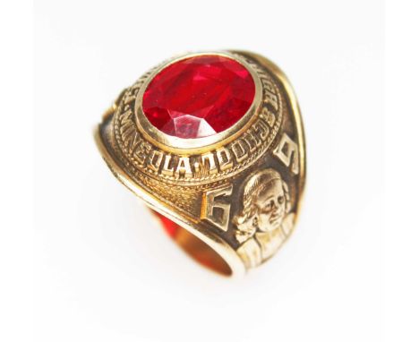 An American college graduation ring, set with an oval synthetic ruby surround by "Chaminade High School Mineola" and insignia