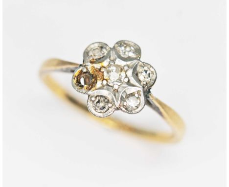 A diamond cluster ring, the flower head cluster measuring approx. 9.06mm, band marked '18ct PLAT', gross wt. 2.0g, size K.  C