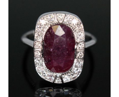 A ruby and diamond cluster ring, the slightly rounded rectangular cluster measuring approx. 19.29mm x 13.51mm, band marked '1