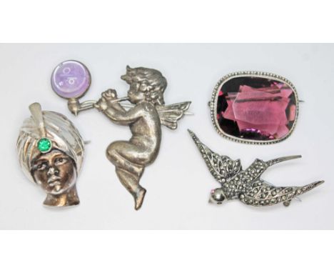 A mixed lot comprising a silver brooch modelled as a young Indian boy's head wearing a turban set with green paste, hallmarke