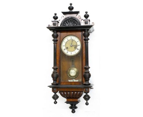 Vienna walnut two-train wall clock, with ebonised pediment and pillared case, 31" high (pendulum and winding key) 